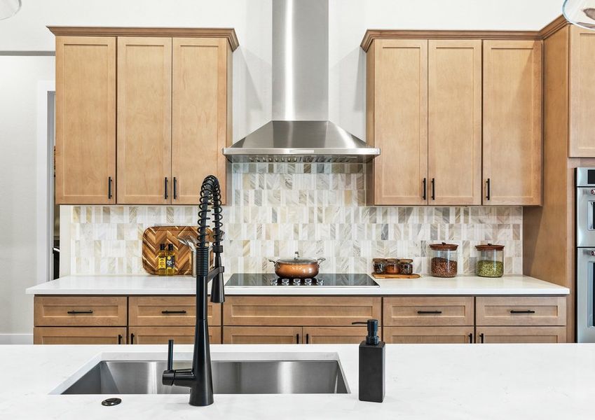 The kitchen has a beautiful tile backsplash.