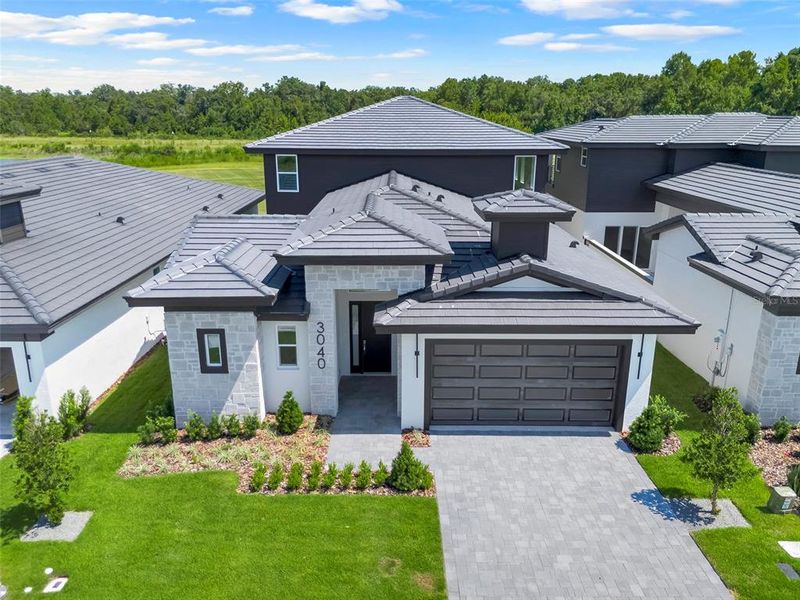 Front exterior of a new home in Hampton Green at Providence, Davenport, FL, highlighting curb appeal (Image 25).