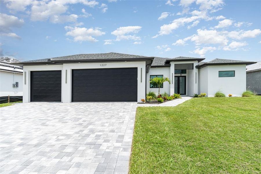 Front exterior of a new home in , Cape Coral, FL, highlighting curb appeal (Image 24).