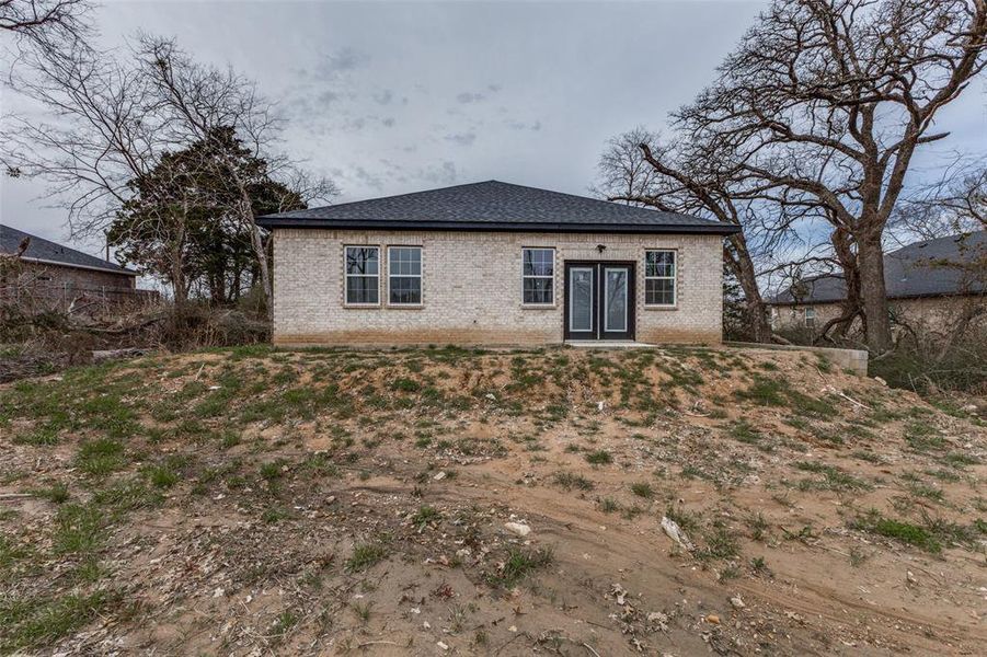 Rear view of house with french doors and brick siding