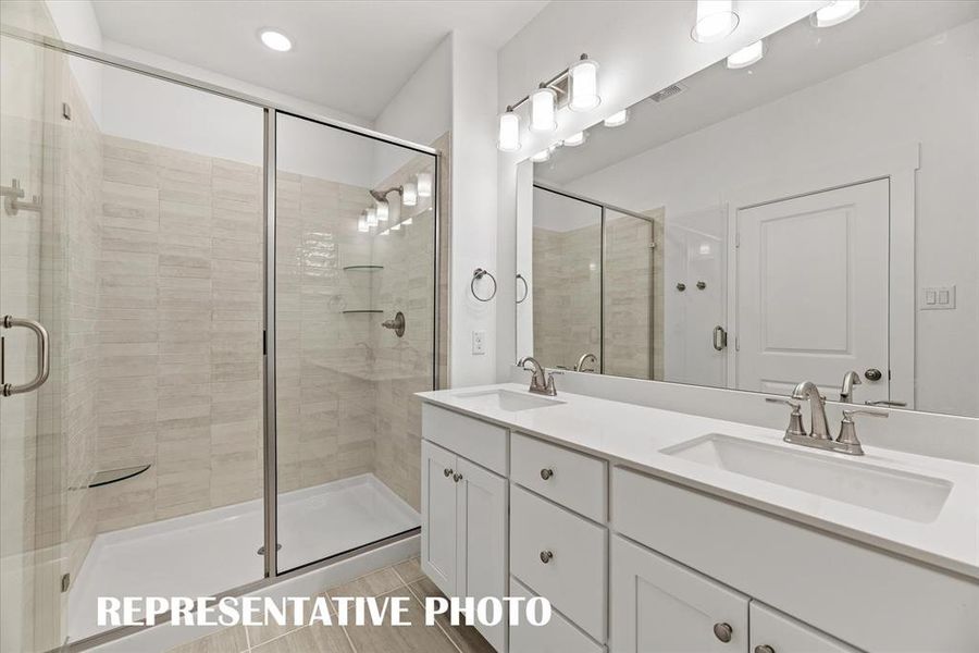 This wonderful owner's bath features an oversized walk in shower and a vanity built for two!  REPRESENTATIVE PHOTO