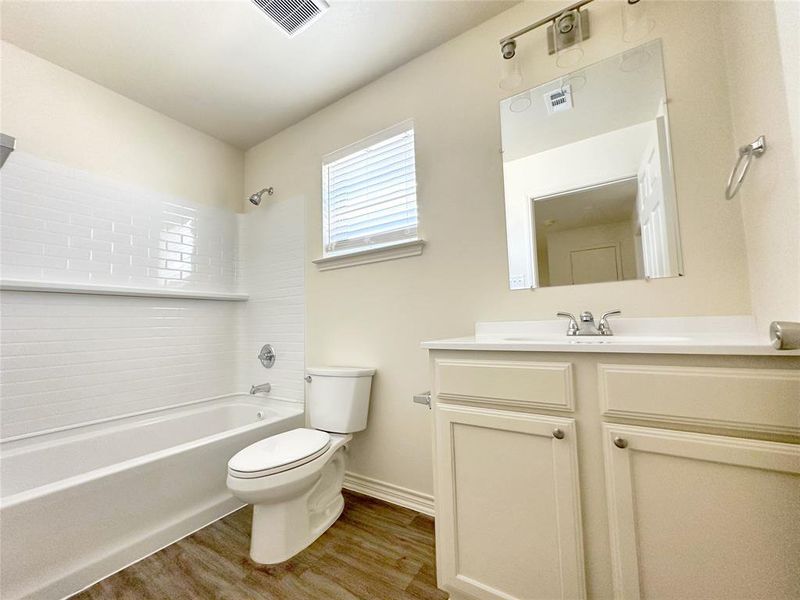 Full bathroom with vanity, tub / shower combination, and wood finished floors