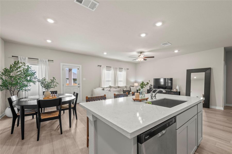 An open floorplan seamlessly connects the kitchen and dining area to the inviting living space. An open floorplan seamlessly connects the kitchen and dining area to the inviting living space.