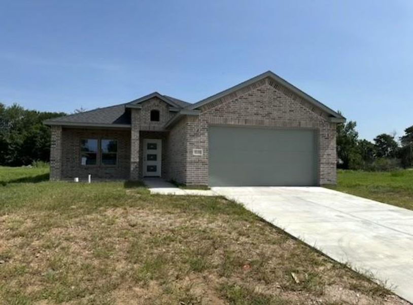 View of front facade featuring brick siding, an attached garage, driveway, and a front yard View of front facade featuring brick siding, an attached garage, driveway, and a front yard