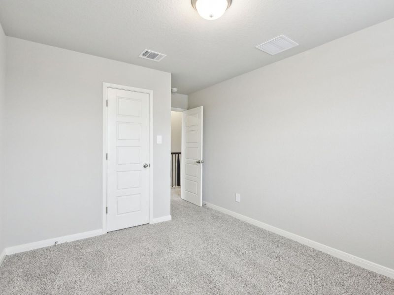 Guest bedroom in the San Jacinto floorplan at a Meritage Homes community.