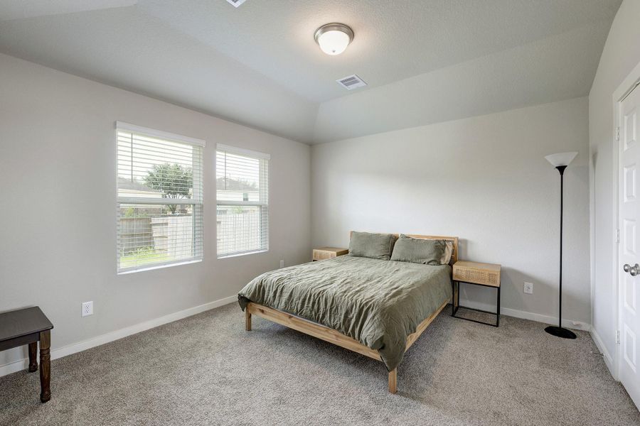 The large primary suite sits at the back of the house in this split floor plan, allowing for maximum privacy and separation from the other bedrooms. The large primary suite sits at the back of the house in this split floor plan, allowing for maximum privacy and separation from the other bedrooms.