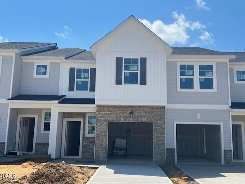Front exterior of a new home in Townes at North Main, Lillington, NC, highlighting curb appeal (Image 25). Front exterior of a new home in Townes at North Main, Lillington, NC, highlighting curb appeal (Image 25).