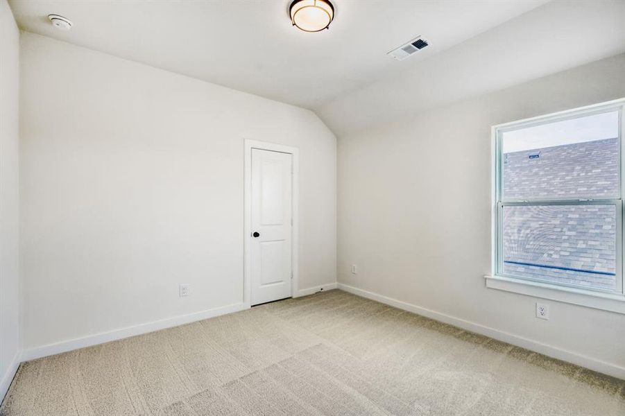 Neutral toned carpeting throughout, white painted walls, white trim, and a single window