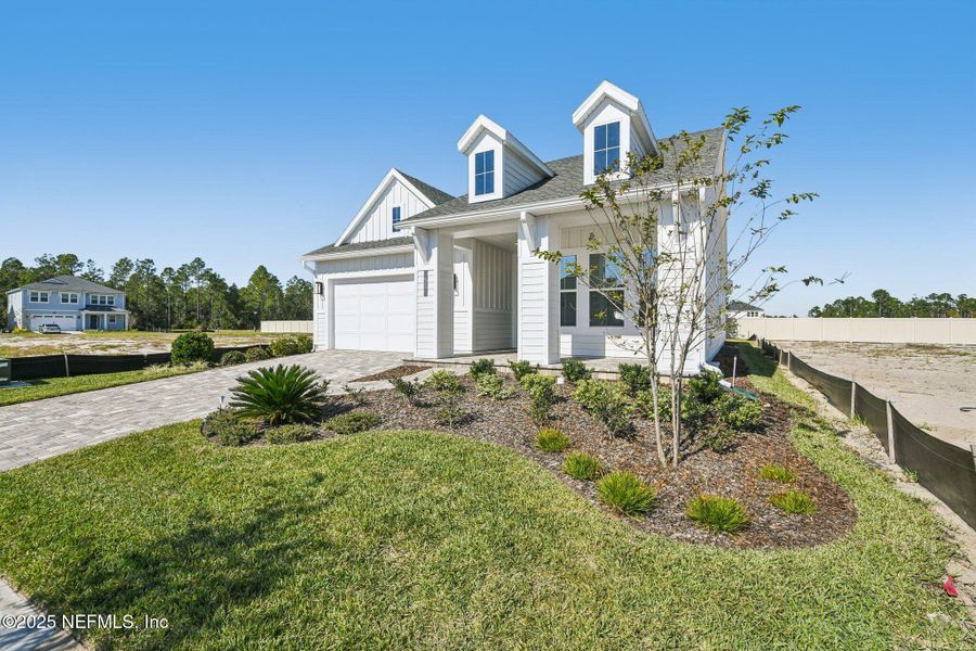 Front exterior of a new home in Seabrook Village II, Ponte Vedra, FL, highlighting curb appeal (Image 27). Front exterior of a new home in Seabrook Village II, Ponte Vedra, FL, highlighting curb appeal (Image 27).