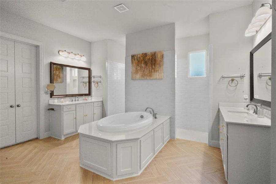 Bathroom featuring a bath and two vanities Bathroom featuring a bath and two vanities