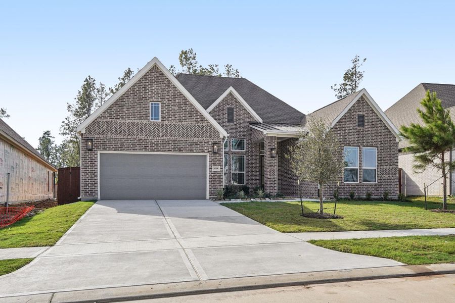 Front exterior of a new home in Evergreen, Conroe, TX, highlighting curb appeal (Image 1). Front exterior of a new home in Evergreen, Conroe, TX, highlighting curb appeal (Image 1).