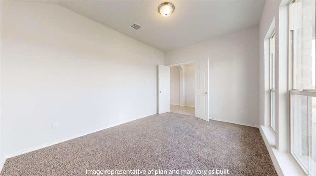 Carpeted room with white walls, a flush-mount ceiling light fixture, and a large window with vertical blinds Carpeted room with white walls, a flush-mount ceiling light fixture, and a large window with vertical blinds