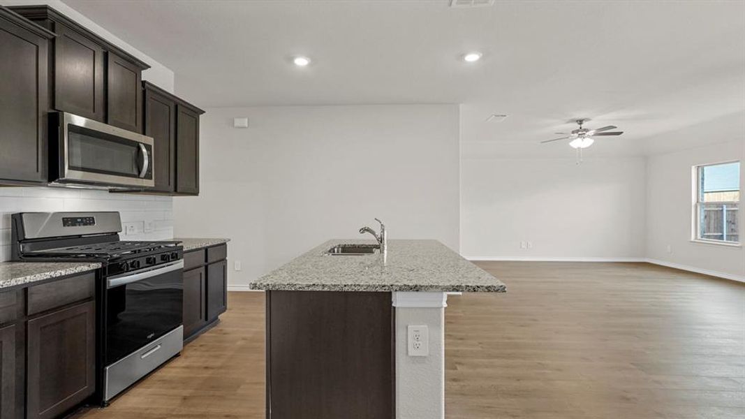 Modern kitchen island with an undermount sink and granite countertop