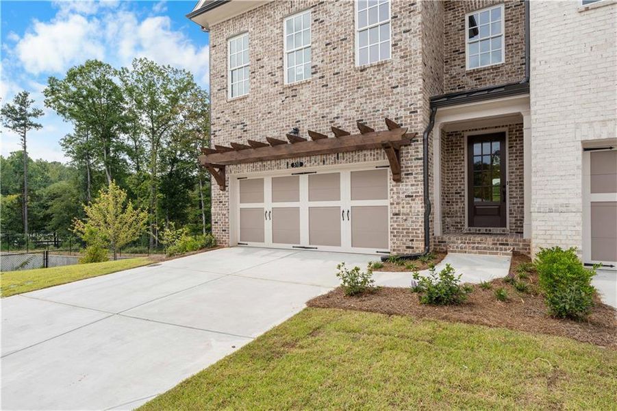 Front exterior of a new home in Ward's Crossing Townhomes, Johns Creek, GA, highlighting curb appeal (Image 28).