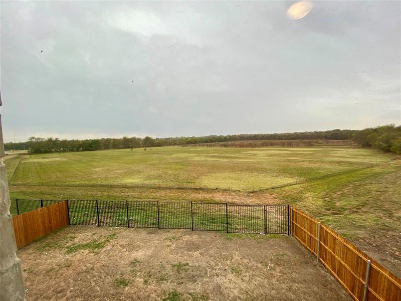 Birdseye view of back yard and vast nature area behind & community pond on the right (landscaping will be installed this week.)