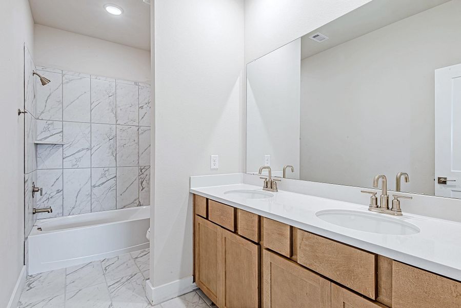 The upstairs full bathroom features a large double vanity with sleek fixtures and modern lighting—perfect for sharing without sacrificing space. The upstairs full bathroom features a large double vanity with sleek fixtures and modern lighting—perfect for sharing without sacrificing space.