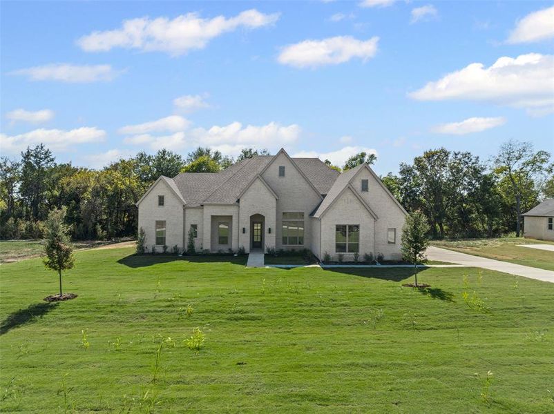 Front exterior of a new home in Waterfall Ranch - 1 Acre Lots, Waxahachie, TX, highlighting curb appeal (Image 2). Front exterior of a new home in Waterfall Ranch - 1 Acre Lots, Waxahachie, TX, highlighting curb appeal (Image 2).
