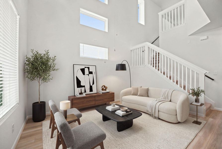 Dramatic soaring ceilings and clean architectural lines define this welcoming entryway living space.
