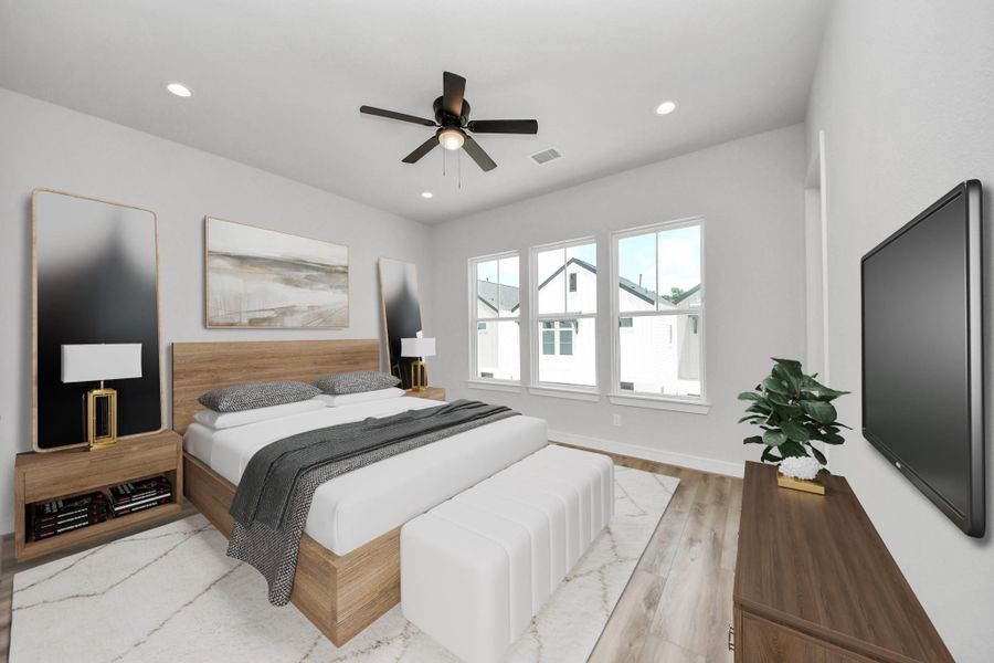 Expansive primary bedroom featuring elegant luxury flooring, a modern ceiling fan, and oversized windows that fill the space with natural light.