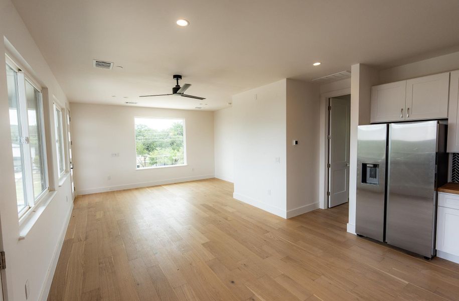 Blonde wood flooring and numerous windows define this sun-filled living space. Blonde wood flooring and numerous windows define this sun-filled living space.