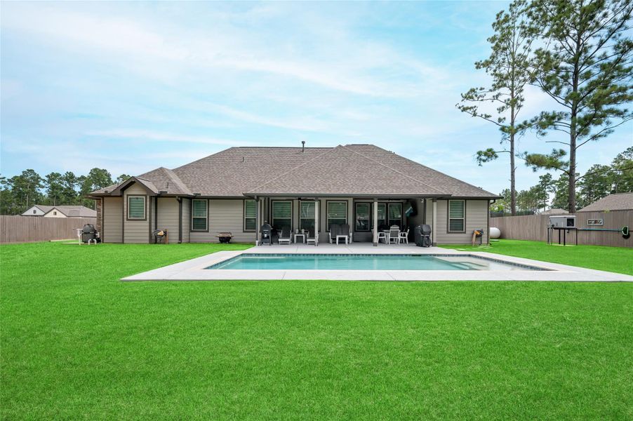 Back view of the home and in-ground pool.