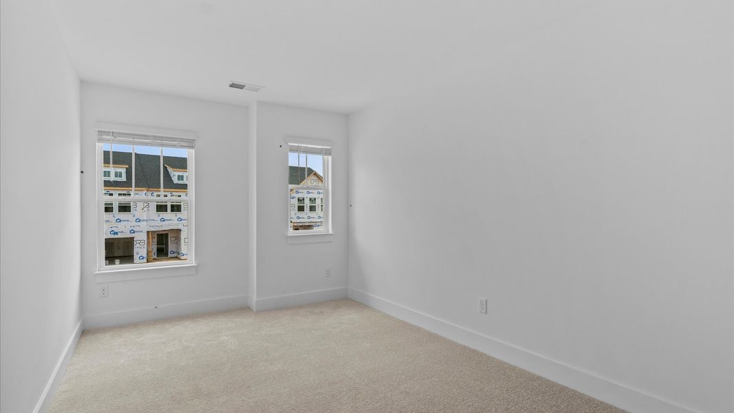 Accomplished design in this restful bedroom featuring plush carpet and oversized window views Accomplished design in this restful bedroom featuring plush carpet and oversized window views