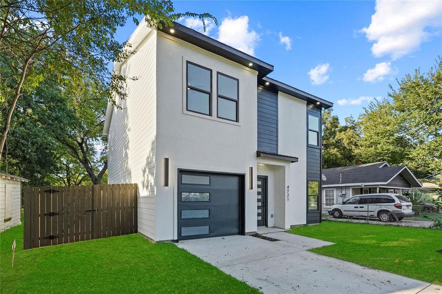 Contemporary house featuring a front yard and a garage