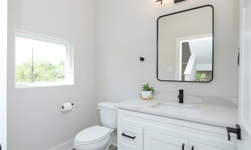 Half bath for guests tucked away in the hallway.