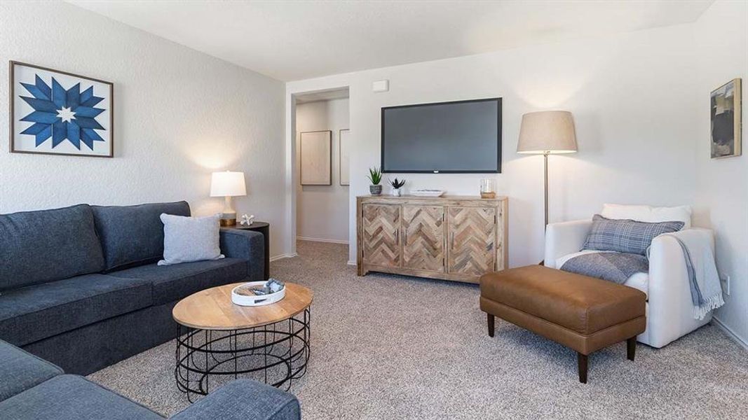 Spacious living area featuring light-colored wall textures, a wall-mounted television, and a built-in wooden media console with herringbone-patterned doors