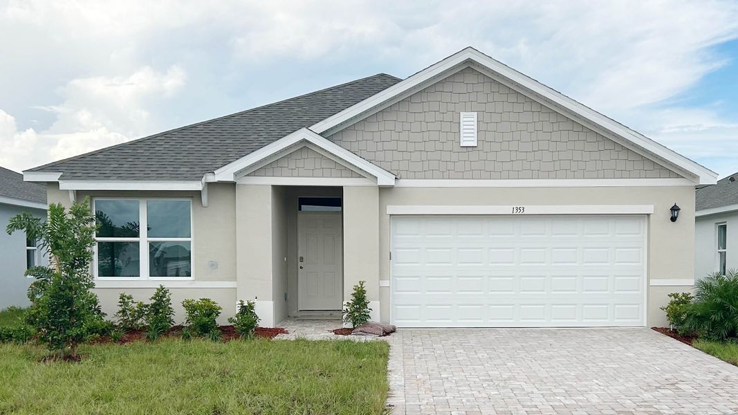 Front exterior of a new home in Cypress Bay West, Palm Bay, FL, highlighting curb appeal (Image 1).