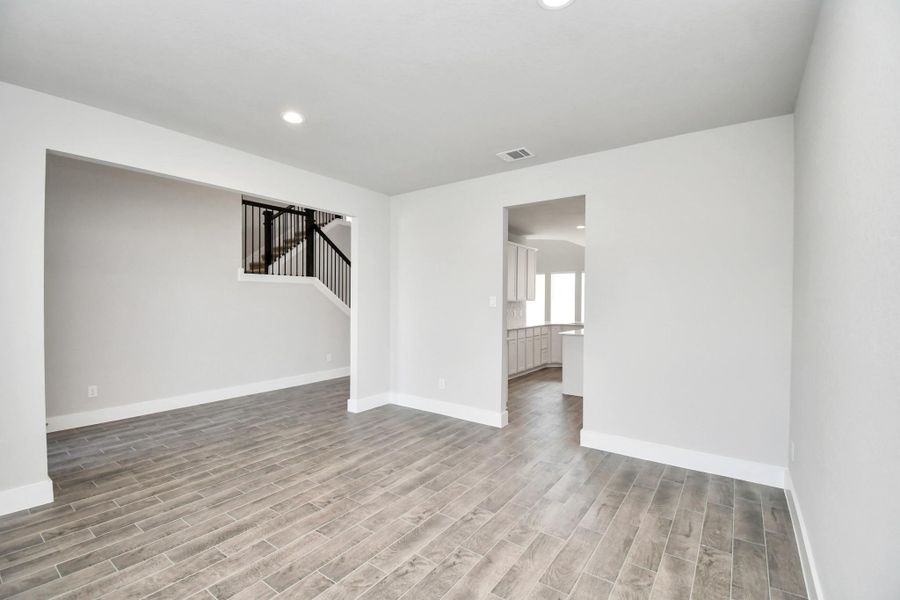 Craft enduring memories with loved ones around the table! This roomy dining area boasts stylish flooring, personalized paint, and is conveniently situated next to the family room and kitchen, fostering an open and inclusive ambiance. Craft enduring memories with loved ones around the table! This roomy dining area boasts stylish flooring, personalized paint, and is conveniently situated next to the family room and kitchen, fostering an open and inclusive ambiance.