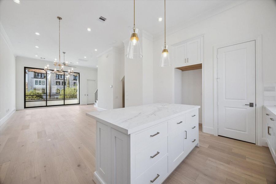 Quartz island. Photos are of a similar home with the same finishes.