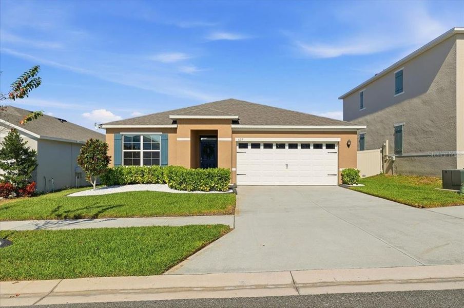 Front exterior of a new home in Eden Hills, Lake Alfred, FL, highlighting curb appeal (Image 27). Front exterior of a new home in Eden Hills, Lake Alfred, FL, highlighting curb appeal (Image 27).