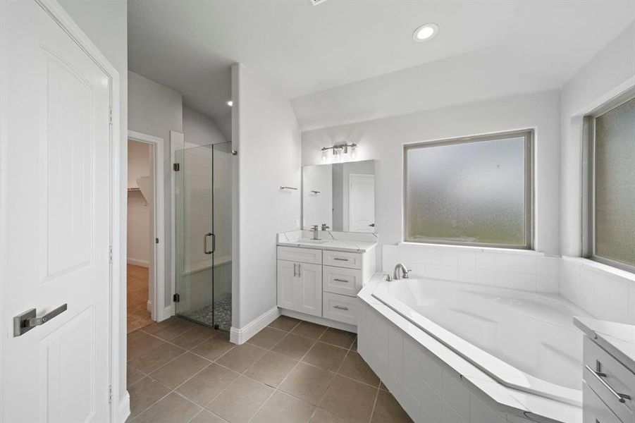 Bathroom featuring vanity, separate shower and tub, and tile patterned flooring