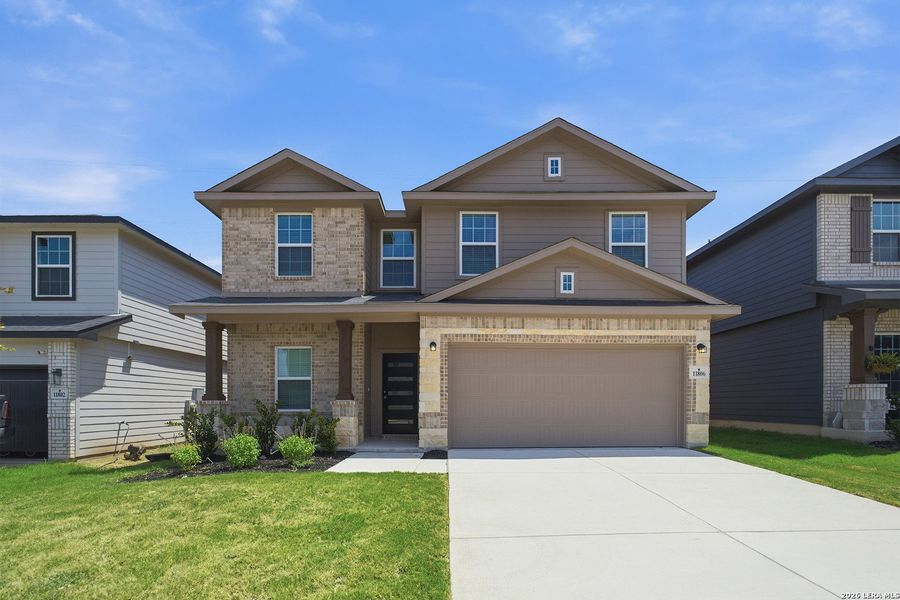 Front exterior of a new home in Laurel Vistas, San Antonio, TX, highlighting curb appeal (Image 2).