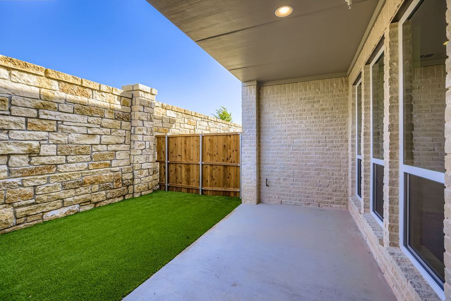 Exterior details and patio area of a home in Castle Hills Northpointe - Townhomes, Carrollton (Image 4). Exterior details and patio area of a home in Castle Hills Northpointe - Townhomes, Carrollton (Image 4).