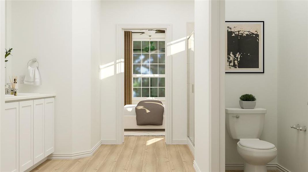 Bathroom featuring walk in shower, hardwood / wood-style floors, vanity, and toilet