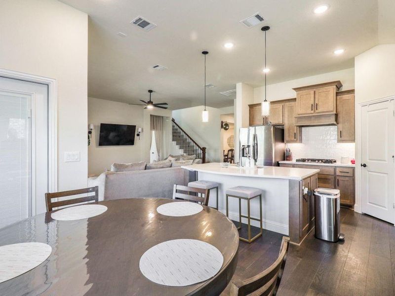 Dining area featuring dark wood-type flooring, ceiling fan, and recessed lighting Dining area featuring dark wood-type flooring, ceiling fan, and recessed lighting
