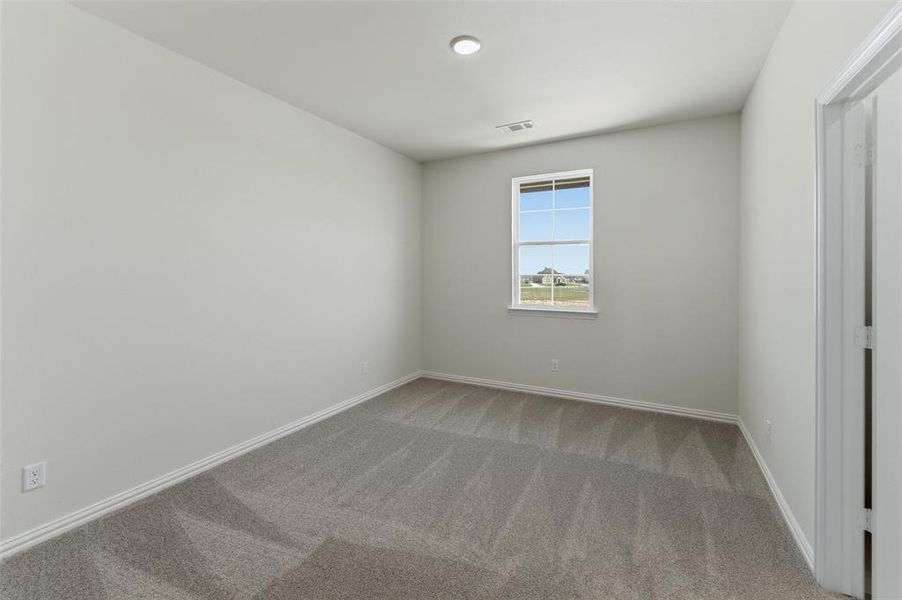 Carpeted empty room with baseboards Carpeted empty room with baseboards