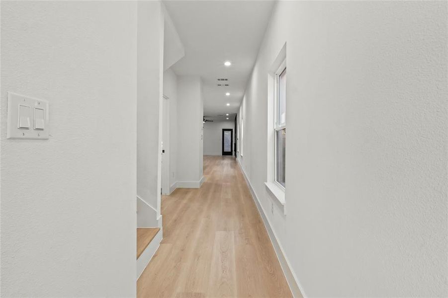 Corridor with light wood finished floors and recessed lighting Corridor with light wood finished floors and recessed lighting