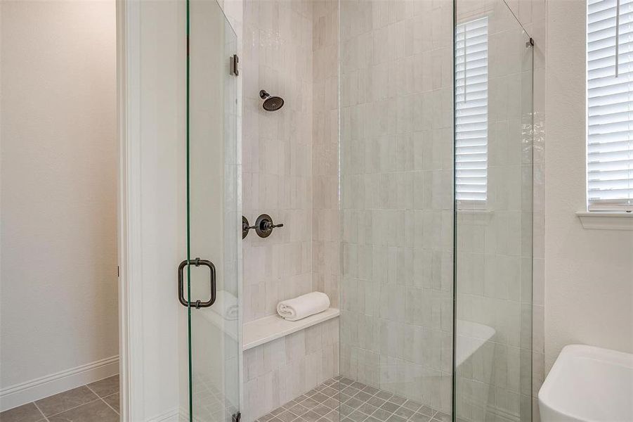 Primary Bathroom with vanity, walk in shower with standard shower head and rain head, freestanding tub, and large walk in shower