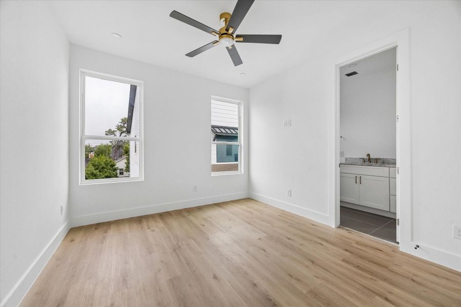 Second bedroom located on the 3rd floor features a walk-in closet, ensuite bath and ceiling fan.