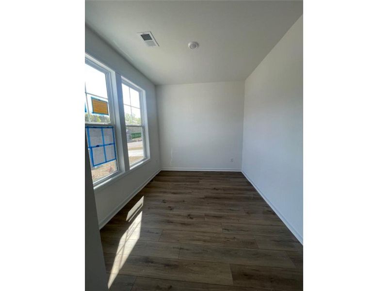 This versatile room features expansive windows and