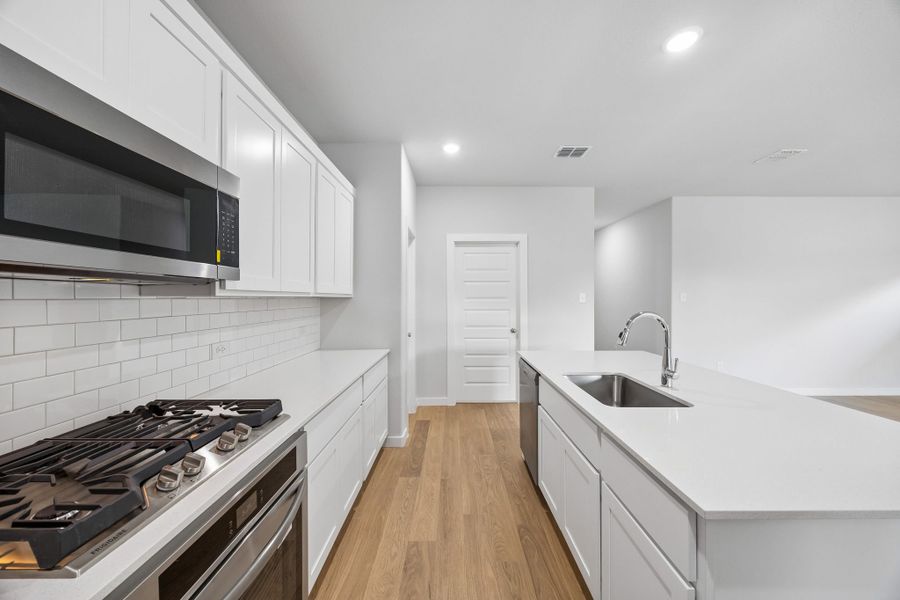 Kitchen in the Oscar home plan by Trophy Signature Homes – REPRESENTATIVE PHOTO