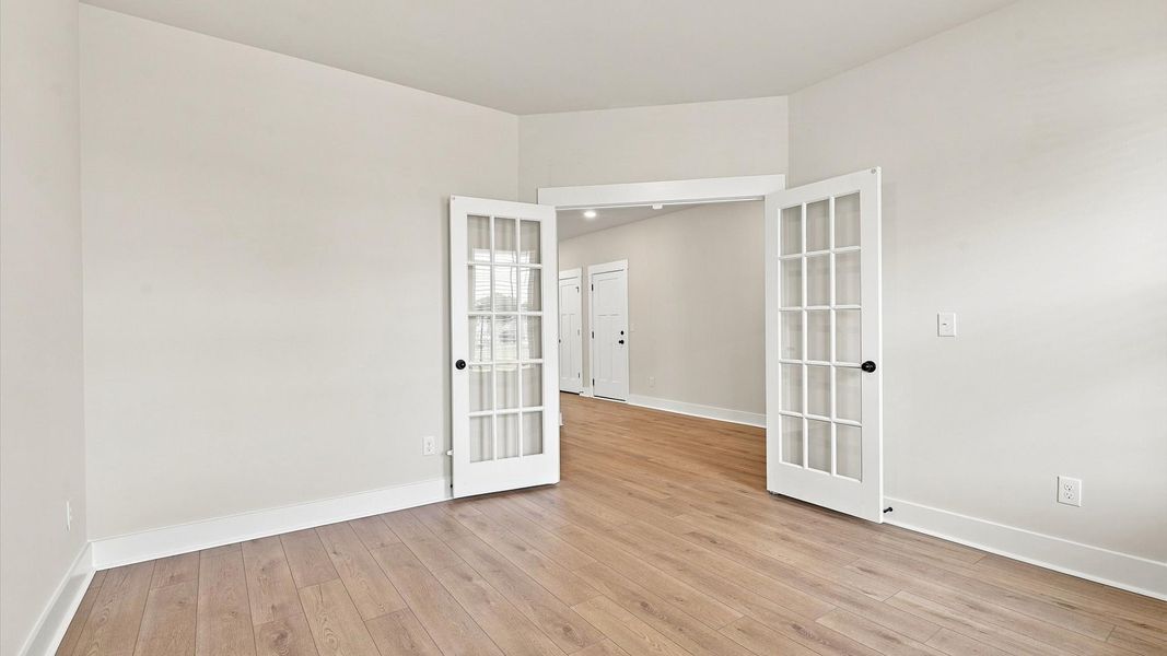 Tasteful French door study offering a quiet, elegant workspace in this vibrant Inman home