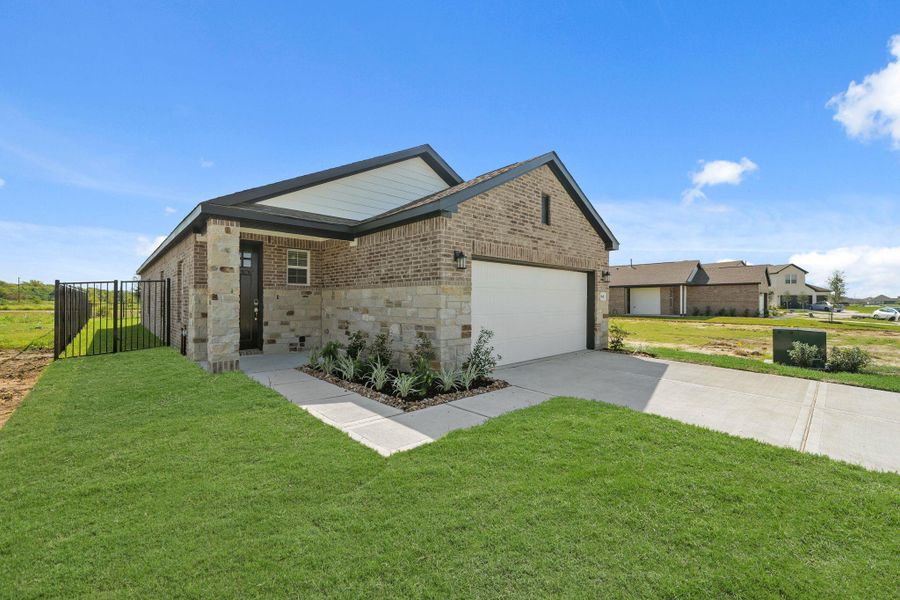 Front exterior of a new home in River Ranch Trails, Dayton, TX, highlighting curb appeal (Image 18).