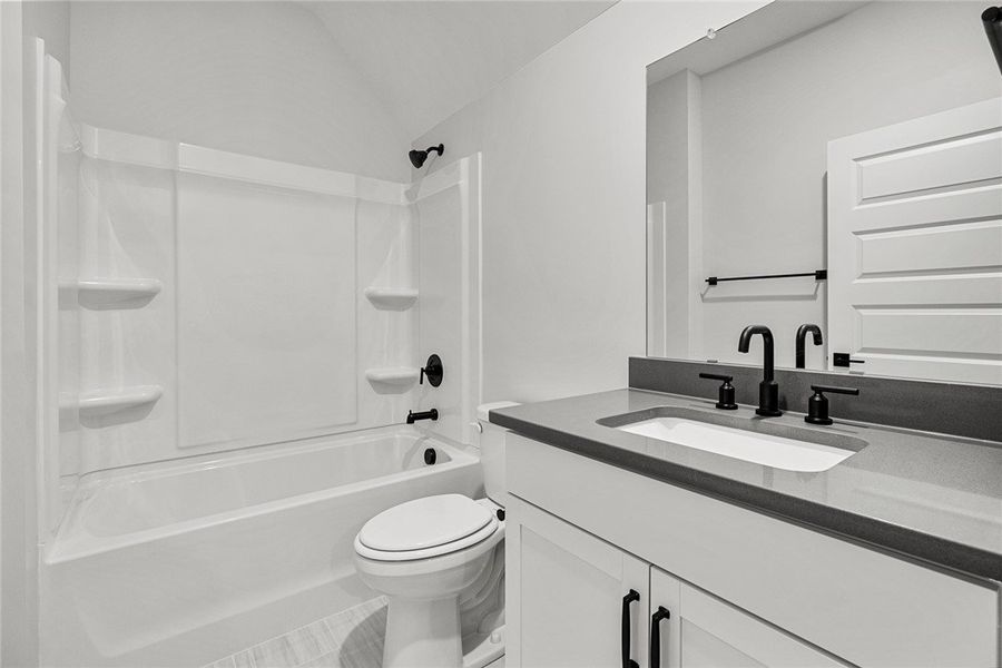 A well-appointed bath features modern matte black A well-appointed bath features modern matte black