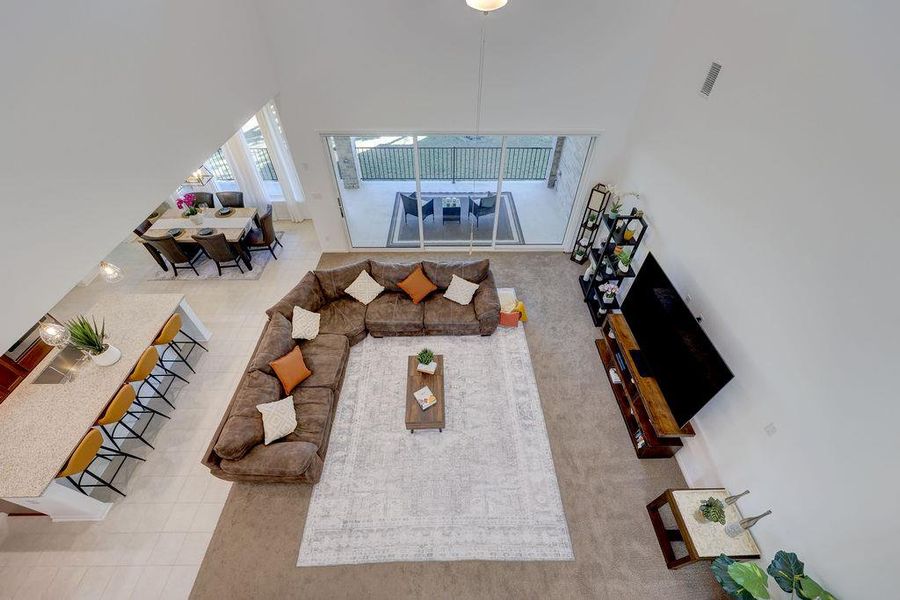 Living area featuring a high ceiling and tile patterned flooring