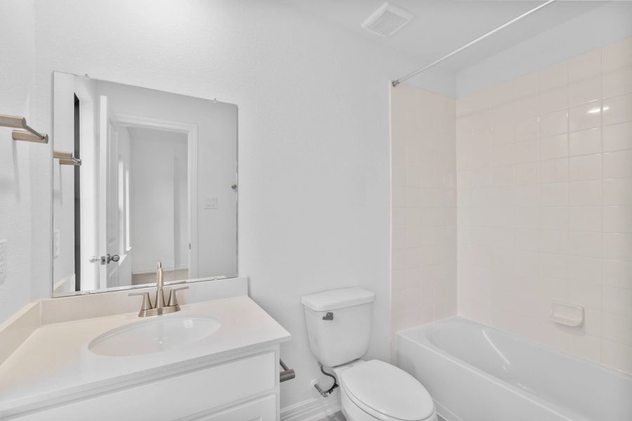 A beautifully finished secondary bathroom showcasing timeless materials and clean lines. A beautifully finished secondary bathroom showcasing timeless materials and clean lines.