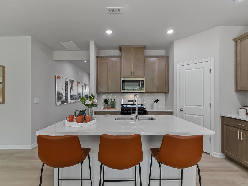 The kitchen provides ample prep and storage space with a sizeable island overlooking the great room.